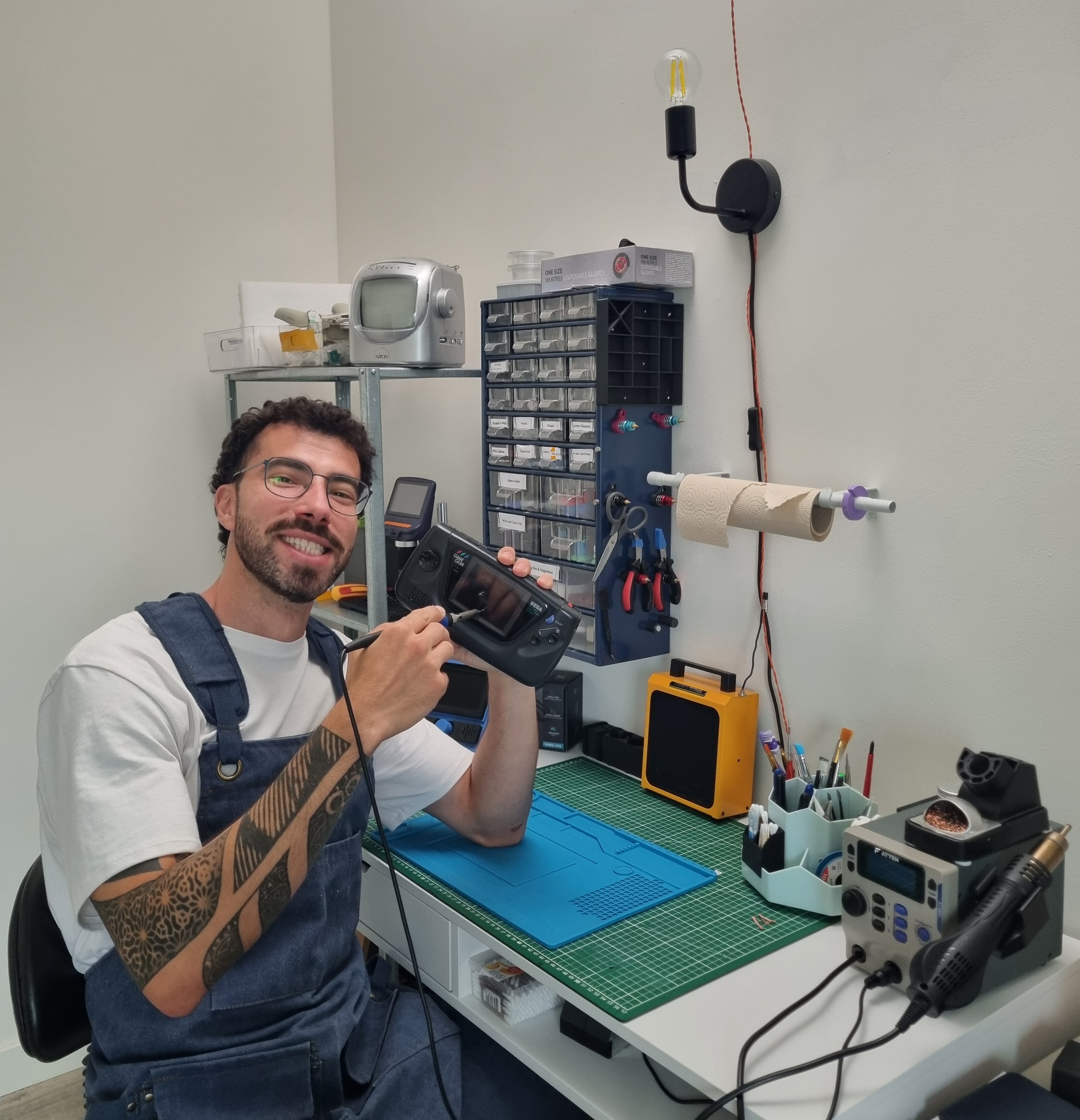 A picture of a nice gentleman sitting in his laboratory.